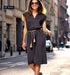 Black satin button-up dress with pockets and a golden tassel belt, perfect for elegant events.